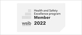 A white and black logo for the health and safety excellence program.