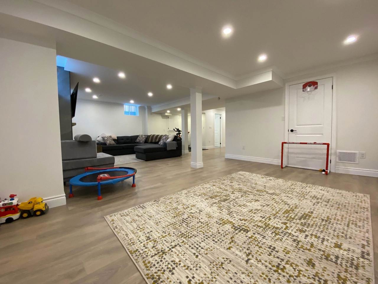 A room with a hockey net and a couch in it