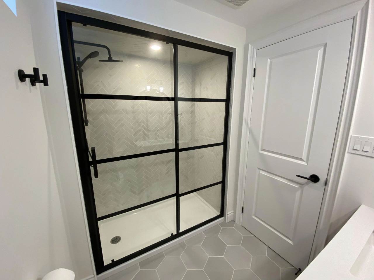 A bathroom with a shower and tiled floor